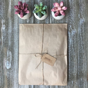 Picture of a package wrapped up with brown paper and string representing the adventure box